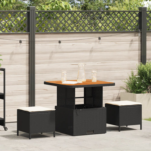 salle à manger de jardin en rotin noir avec coussins crème