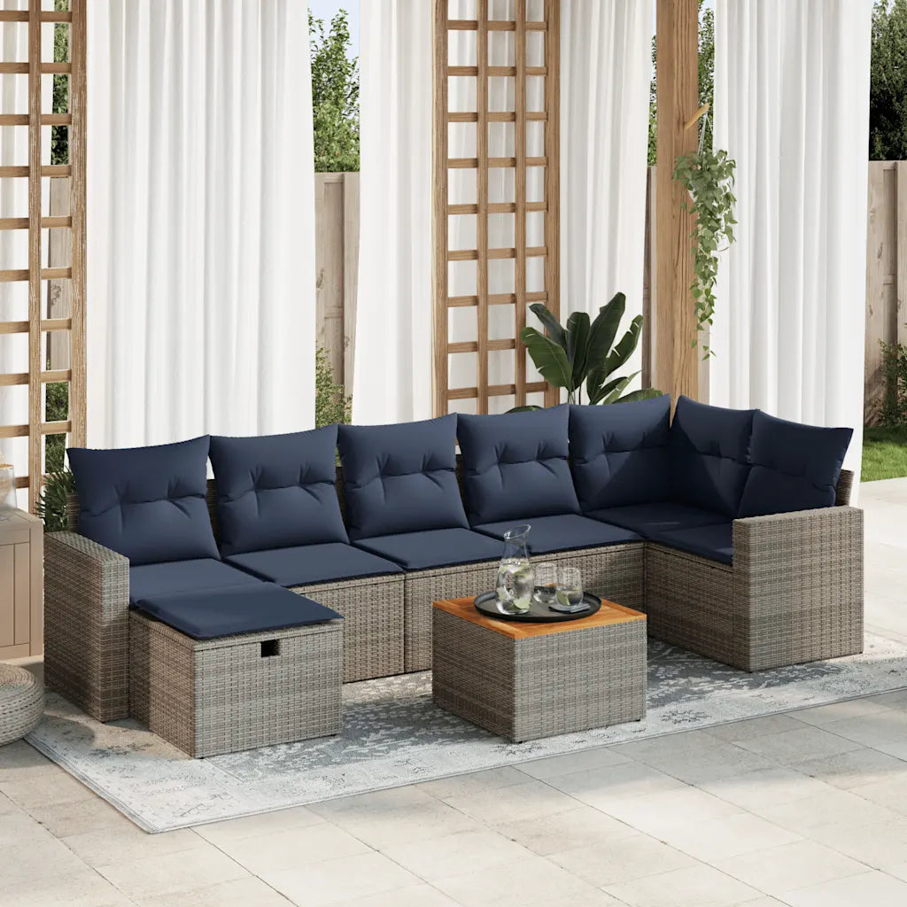Salon de jardin gris en polyrotin avec coussins bleu marine sur terrasse moderne.