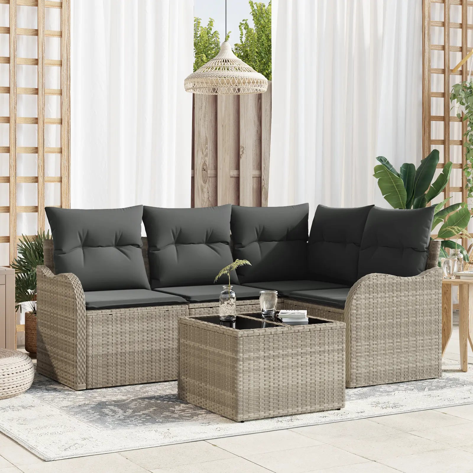 Ensemble de jardin modulable en résine tressée grise.